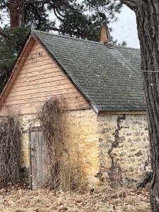 photo of an old stone and wood fruit house from a 1950s ranch